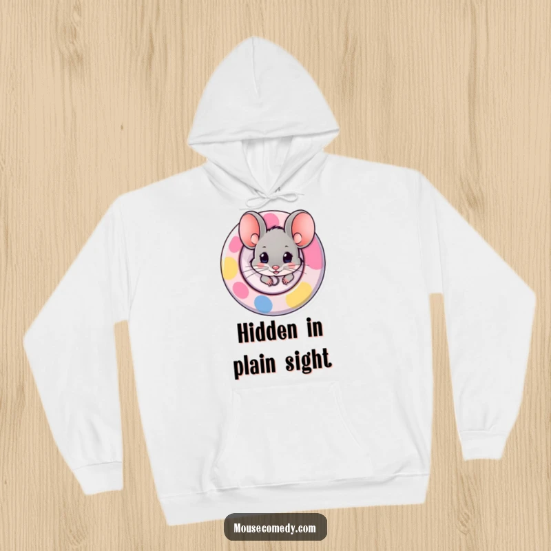 Funny hoodie graphic of a mouse peeking out from behind a large, bright button, hinting at playful mischief and hidden charm.
